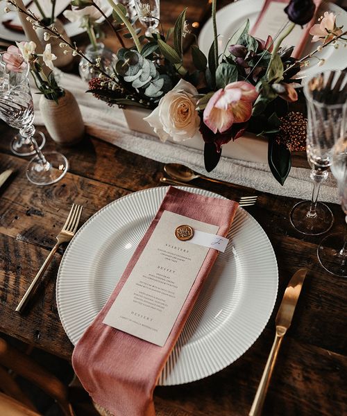 wedding menu card on pink napkin for place setting
