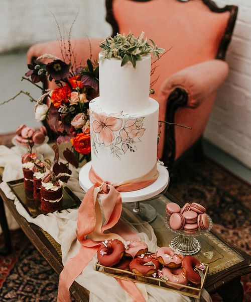 painted wedding cake and terracotta wedding inspiration in an industrial wedding venue