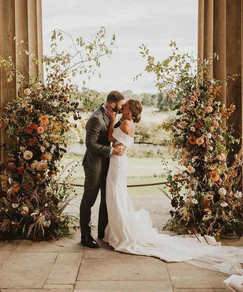 Boho autumnal wedding column flower arrangements.