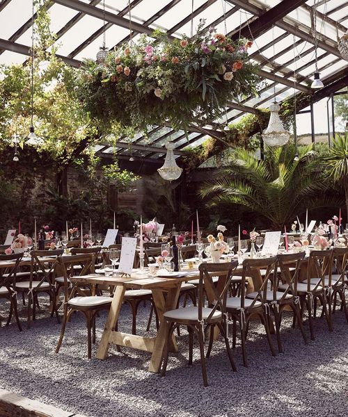 Anran wedding venue with hanging flower installations and chandeliers.