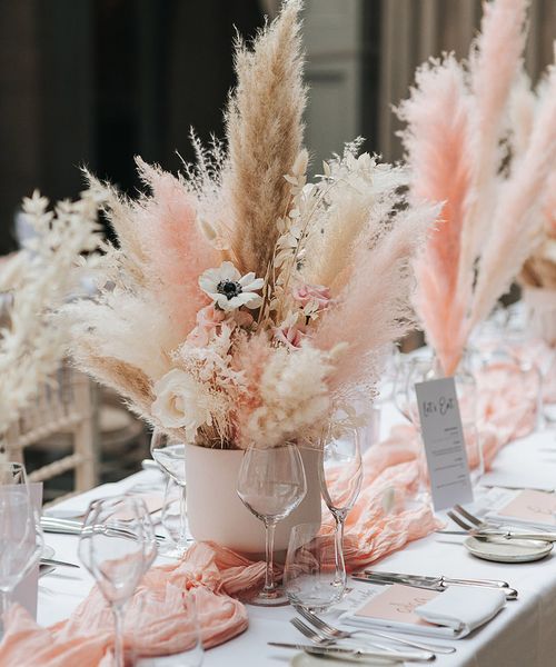 Pink and white pampas grass centrepiece decor for boho wedding.