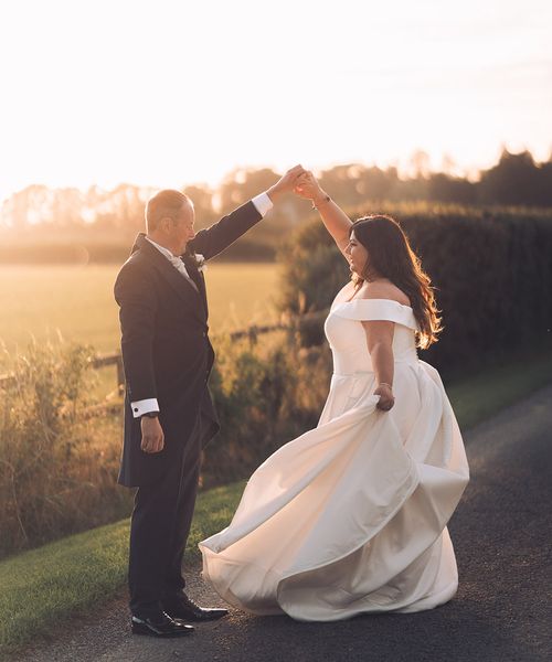 The bride and groom dance together during sunset at Stratton Court Barn Bicester.