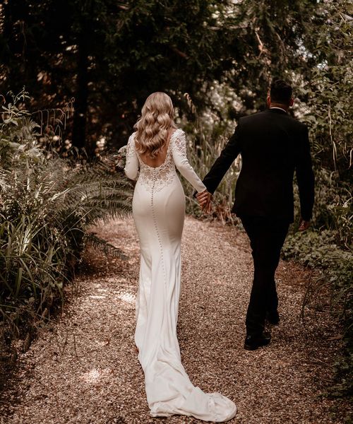 Bride in lace back Badgley Mischka wedding dress and groom in black tie for Pennard House wedding.