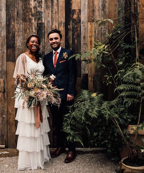 Black bride in a bespoke wedding dress at 100 Barrington wedding venue with pampas grass decor