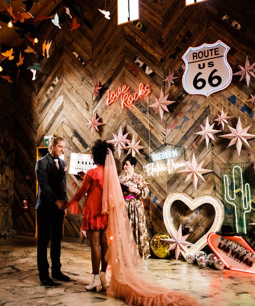 Fun Neon wedding inspiration at The Canary Shed in Essex with Red wedding dress, and colourful flowers 