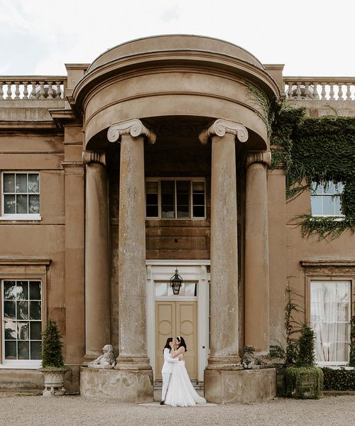 Brides share a kiss at their wilderness reserve wedding 