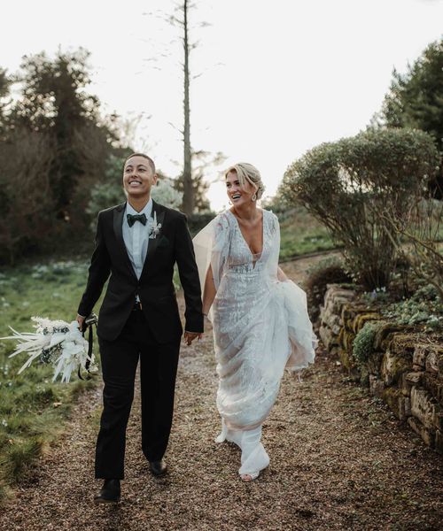 hodsock Priory LGBTQI+ wedding with lace wedding dress, tuxedo and column gypsohila clouds