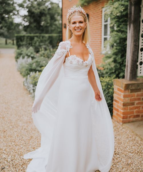 Bride in a handmade wedding dress, bridal cape and crown.