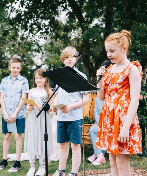 Child performing a reading at a wedding from children's wedding readings.