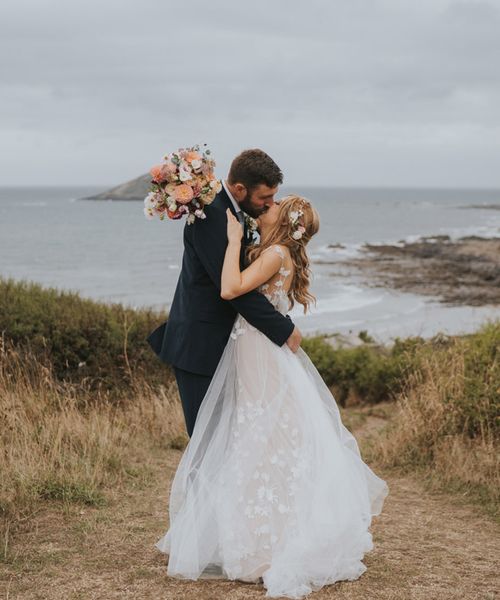 Bride in Anna Kara wedding dress kissing the groom at Devon wedding.