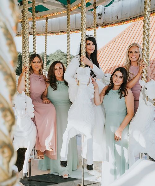 Pink and green wedding theme and bridesmaid dresses for carousel fairground wedding.