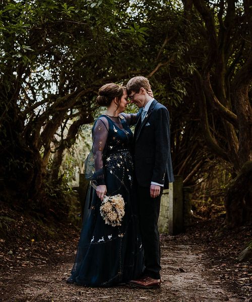 Bride in a bespoke navy blue wedding dress for celestial theme wedding.