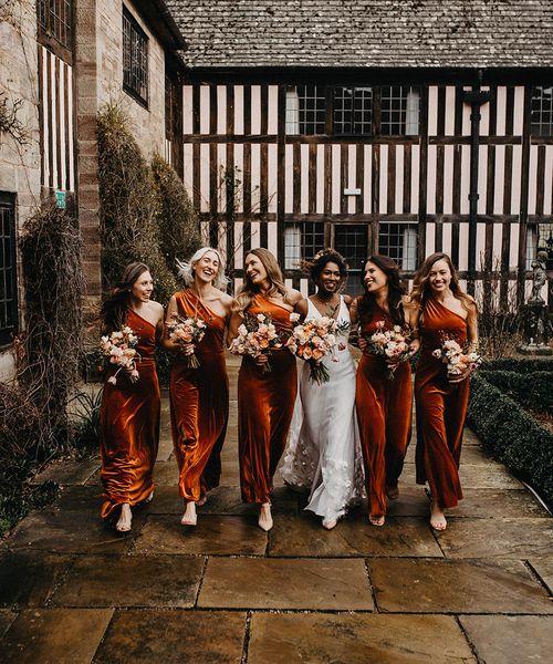 autumn bridesmaid dresses for bridal party in matching orange gowns