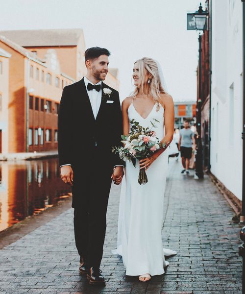 Intimate Gas Street church wedding with the bride in a slip wedding dress and the groom in a tuxedo 