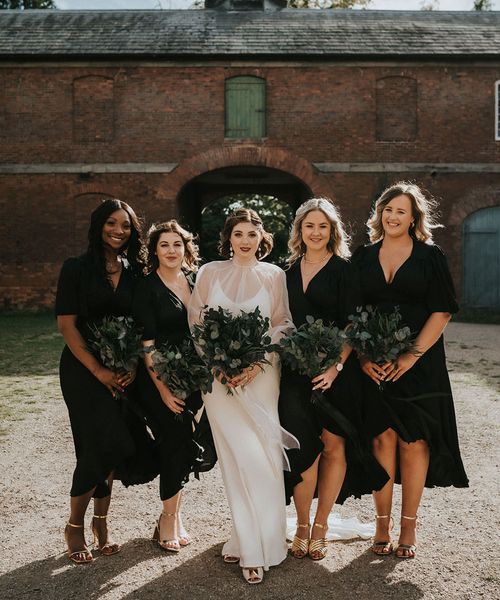 Bride and bridesmaids all holding preserved flower bouquets.