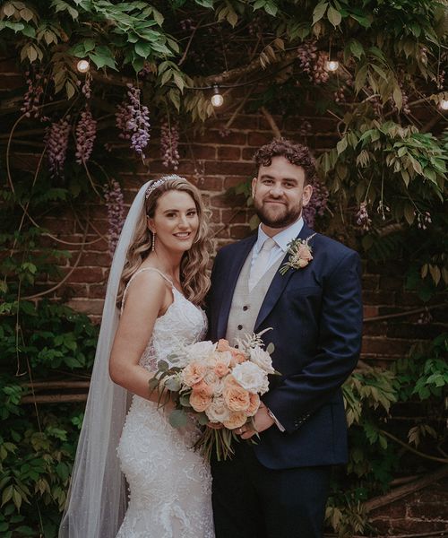 Stanlake Park Wedding with the bride in a lace wedding dress and groom in dark blue suit.