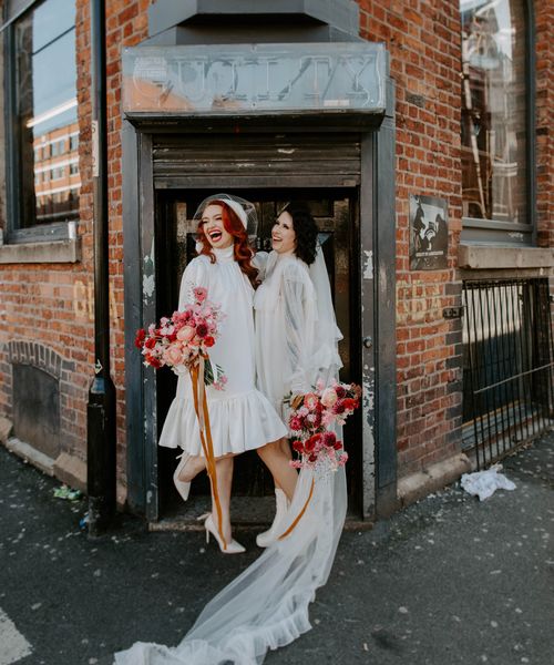 short wedding dress long veil bridal inspiration with red wedding flowers, winged eyeliner and bold lipstick