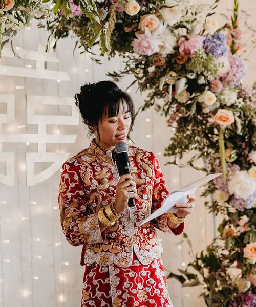 Bride in Chinese wedding attire reading out modern wedding reading