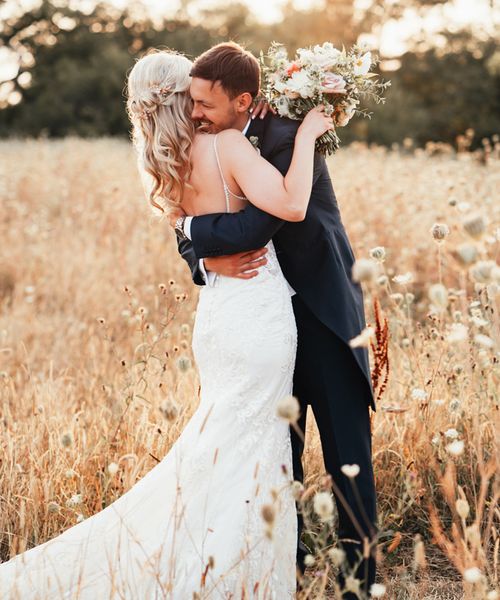 Bride and groom posing together at Rackleys Chiltern Hills barn wedding venue in Buckinghamshire.