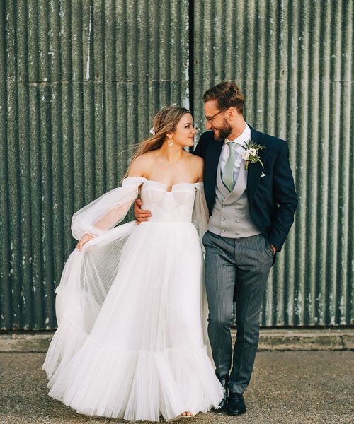 Bride in tulle wedding dress by Alena Leena Bridal with groom. 