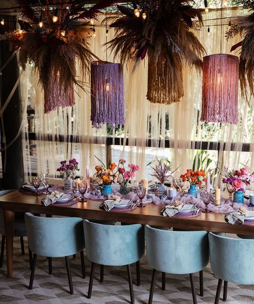 Brazil destination wedding at villa mandacaru with purple theme tablescape and statement hanging lights