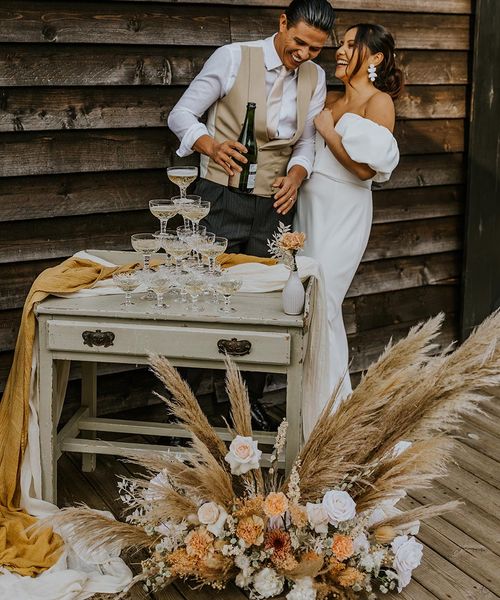 Boho wedding inspiration at The Canary Shed with a muted colour palette, drapes, macrame and wicker wedding decor by Aurora Grey Photography