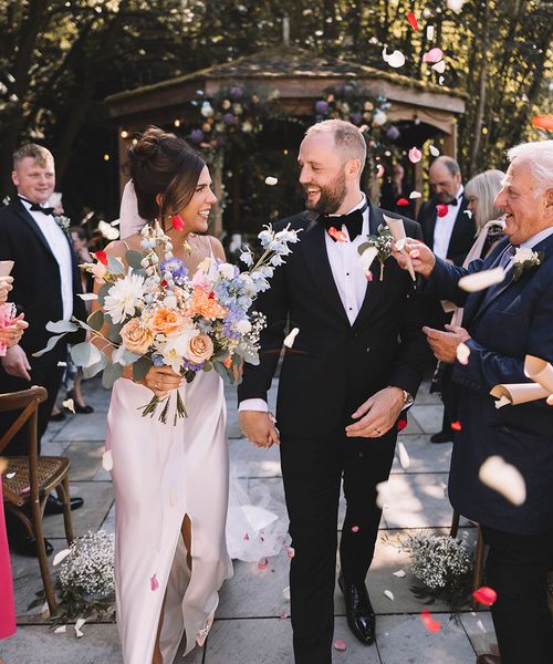 Confetti exit from Bowers Mill outdoor wedding ceremony with pastel wedding theme 