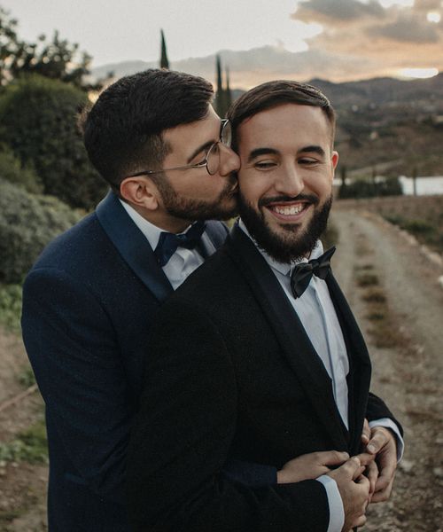 Hotel Cortijo Bravo Malaga wedding with two grooms In black and blue tuxedos, multicoloured pride mug favours and a Drag Queen act.