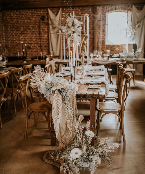 bohemian luxe wedding in a barn with white flowers and natural decor 