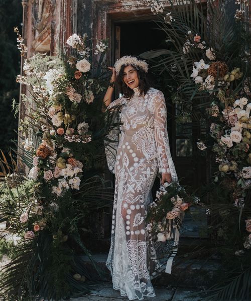 Boho destination Larmer Tree wedding inspiration with palms, muted florals and a lace wedding dress