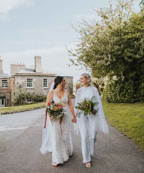 LGBTQI+ wedding with bride in handmade bridal jumpsuit with cape for five day long wedding adventure