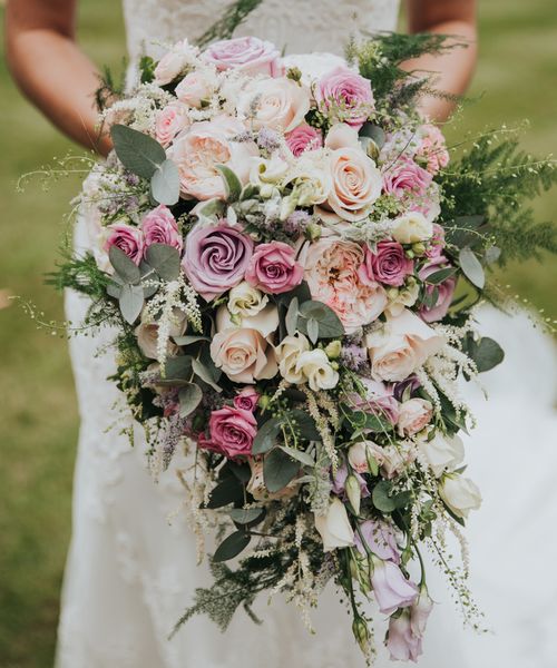 pink lilac and white bouquet filled with roses and lisianthus for bride wearing Christina Wu dress