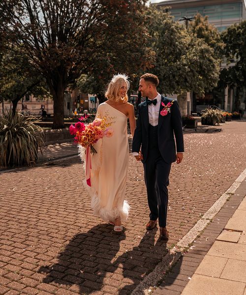 bride-in-cold-shoulder-feather-wedding-dress-with-groom-at-hackney-wedding