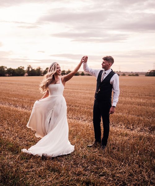 groom-spins-bride-around-for-wedding-photos