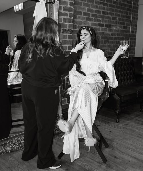 bride-in-satin-robe-gets-wedding-makeup-professional-done