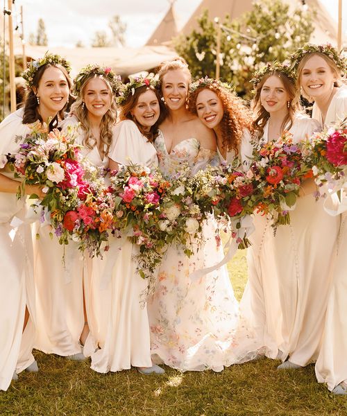 bridesmaids-wearing-ivory-dresses-with-flower-crowns-at-garden-wedding