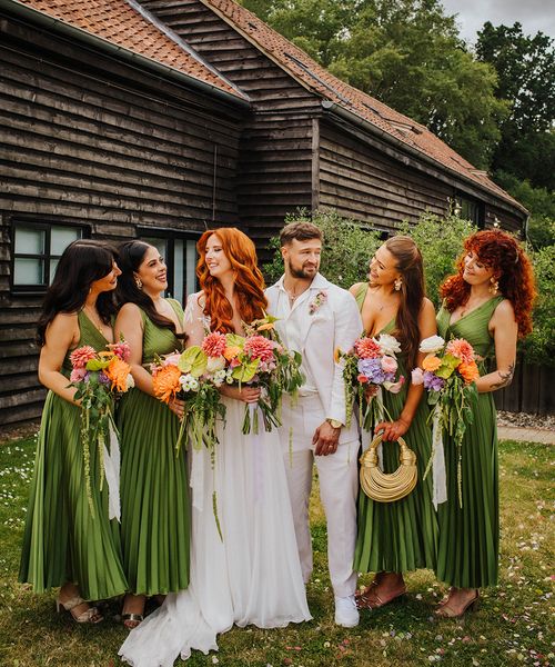 bridal-party-wearing-dark-green-pleated-bridesmaid-dresses