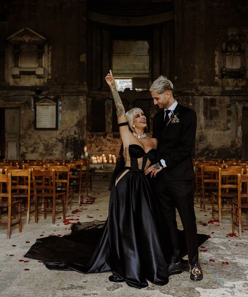 bride-wearing-custom-black-wedding-dress-with-groom-at-gothic-wedding