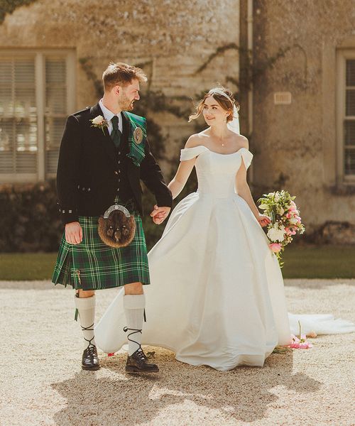 groom-in-green-kilt-with-bride-in-corset-off-the-shoulder-wedding-dress-at-luxe-country-house-wedding