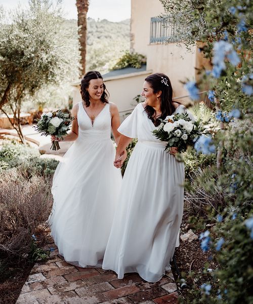 two-brides-wearing-floaty-wedding-dresses-at-destination-wedding