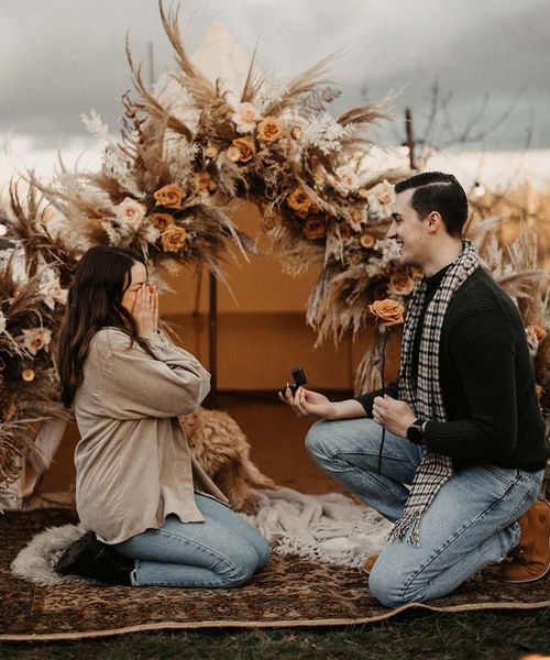 man-proposes-to-woman-in-boho-bell-tent