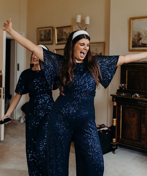 bridesmaids, wedding guests wearing glittery navy jumpsuits for weddings 