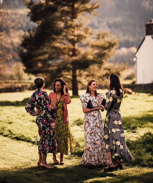 wedding guests wearing long sleeve floral wedding guest dresses for outdoor wedding