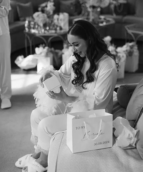 bride opening gifts on the wedding morning