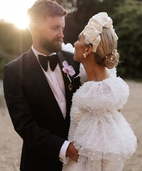 bride-with-pearl-puff-sleeves-with-groom-at-golden-hour