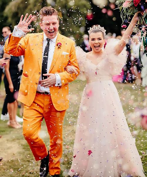 groom wearing colourful, unique mustard orange groom on wedding day