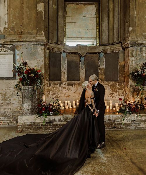 Bride wearing a black wedding dress with long train