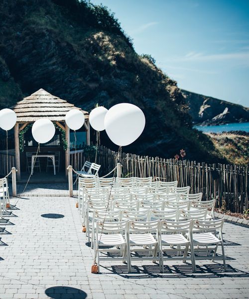 Gypsophila Arch and Giant Balloons for an Outdoor Coastal Wedding | Strapless Pronovias Ballgown Dress | ASOS Bridesmaids Dresses | Toby Lowe Photography