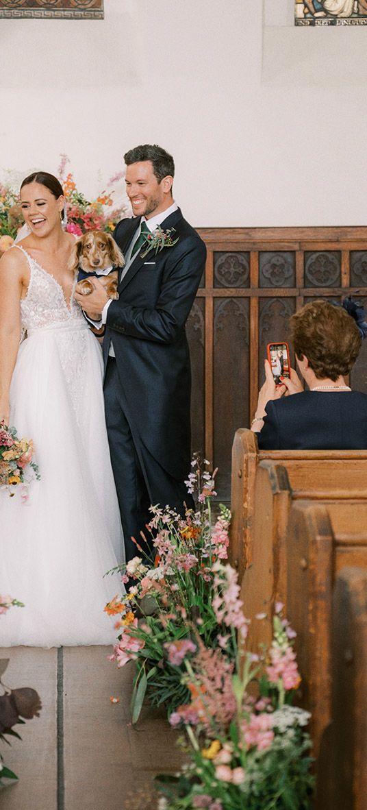 wedding wildflower arrangements decorate the aisle