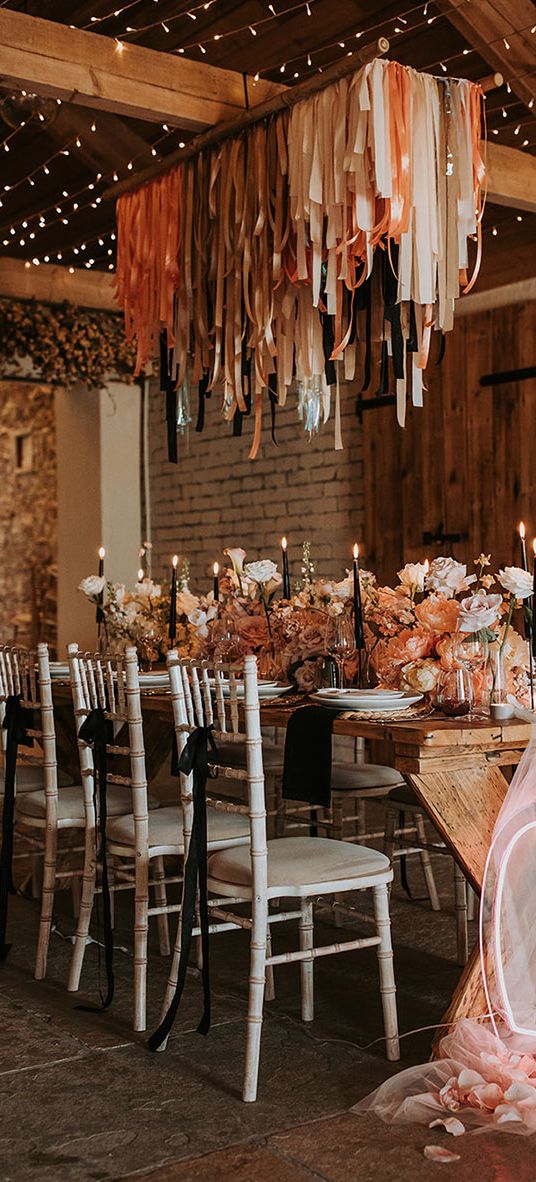 Eden Barn wedding with neon sign, fringe garland and black accent candles